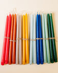 Set of colorful candles tied together on a beige background