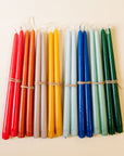 Set of colorful candles tied together on a beige background